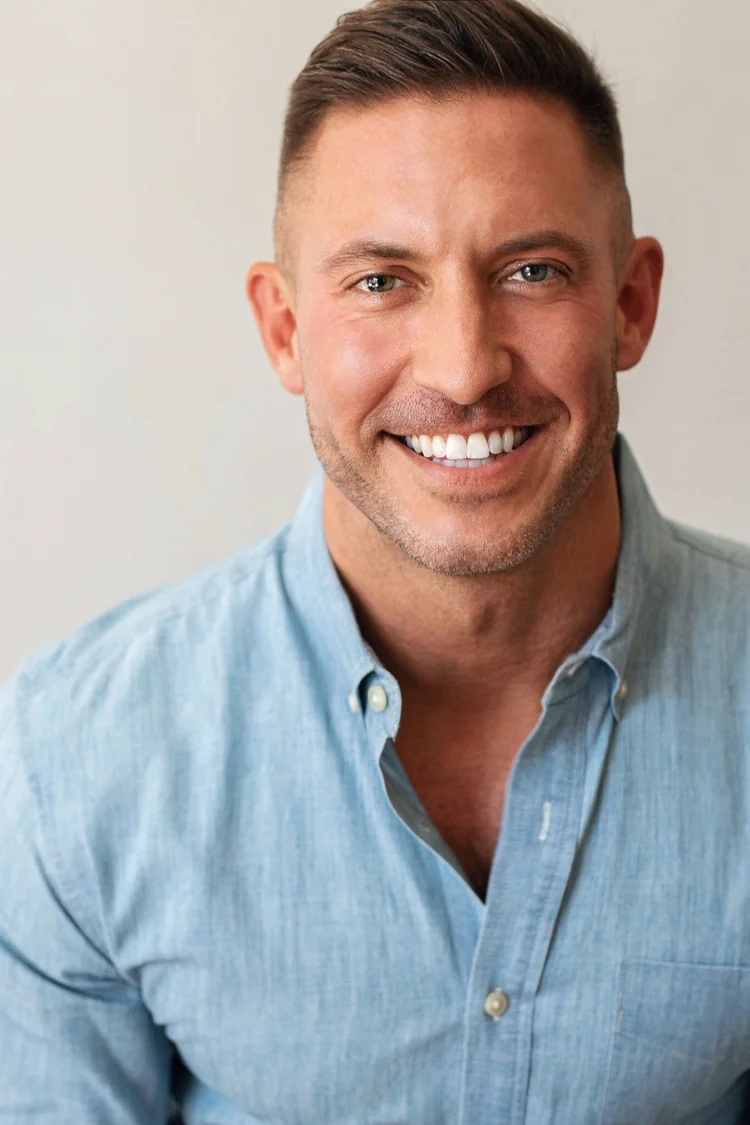 Nick Hodulik, smiling, in a light blue shirt